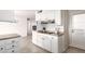 Well-lit kitchen featuring white cabinets, stainless steel appliances, and tile flooring at 10815 W Hatcher Rd, Sun City, AZ 85351