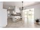 Open kitchen and dining area featuring barstool seating and modern light fixture at 10815 W Hatcher Rd, Sun City, AZ 85351