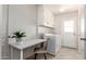 Bright laundry room featuring a desk and ample storage space at 10815 W Hatcher Rd, Sun City, AZ 85351