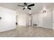 Neutral living room featuring ceramic tile floors, modern fan, and a spacious layout at 10815 W Hatcher Rd, Sun City, AZ 85351