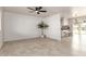 Bright, open living area with stylish tile flooring, contemporary fan, and an open layout at 10815 W Hatcher Rd, Sun City, AZ 85351