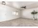 Inviting living room featuring light ceramic tile floors, a contemporary ceiling fan and natural light at 10815 W Hatcher Rd, Sun City, AZ 85351
