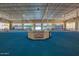 Indoor pickleball court featuring a central desk and a well-lit recreational space at 10815 W Hatcher Rd, Sun City, AZ 85351