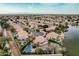 A high aerial view of a lakeside community featuring well maintained houses and lush landscaping at 11101 W Sieno Pl, Avondale, AZ 85392