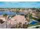 Stunning aerial view of home featuring a pool, lake access, and lush landscaping at 11101 W Sieno Pl, Avondale, AZ 85392