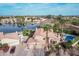 Stunning aerial view of home featuring a pool, lake access, and lush landscaping at 11101 W Sieno Pl, Avondale, AZ 85392