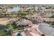Expansive aerial view showcasing a luxury home with manicured lawn, beautiful landscaping, and neighborhood with lake access at 11101 W Sieno Pl, Avondale, AZ 85392