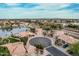 High aerial shot showcasing a well-planned community nestled along a serene lake with lush greenery at 11101 W Sieno Pl, Avondale, AZ 85392