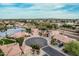Aerial view of a quiet neighborhood with well-maintained homes, circular driveways, and mature trees at 11101 W Sieno Pl, Avondale, AZ 85392