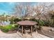 Stunning outdoor gazebo with a fire pit surrounded by comfortable seating and lush landscaping at 11101 W Sieno Pl, Avondale, AZ 85392