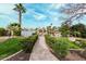 A backyard view of a lake with manicured landscaping and a stone pathway at 11101 W Sieno Pl, Avondale, AZ 85392