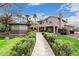 A well-manicured backyard featuring a gazebo, patio, tropical plants, and a lawn at 11101 W Sieno Pl, Avondale, AZ 85392