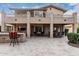 A spacious backyard patio featuring an outdoor kitchen and dining area on the lower level at 11101 W Sieno Pl, Avondale, AZ 85392