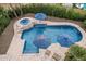 A sparkling pool with spa, complemented by striped umbrellas, and comfortable lounge seating at 11101 W Sieno Pl, Avondale, AZ 85392