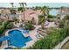 Gorgeous backyard featuring a sparkling pool, lush greenery, tiled patio, and outdoor seating at 11101 W Sieno Pl, Avondale, AZ 85392