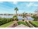 Scenic view of the lakefront property with a lush green lawn and private dock at 11101 W Sieno Pl, Avondale, AZ 85392