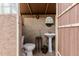 Outdoor bathroom features stylish tile, a pedestal sink, and a glass block accent mirror at 11101 W Sieno Pl, Avondale, AZ 85392