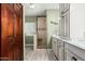 Bathroom featuring a glass enclosed shower, wood look floors, and custom vanity with storage at 11101 W Sieno Pl, Avondale, AZ 85392
