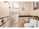 Bathroom featuring a tiled shower and toilet at 11101 W Sieno Pl, Avondale, AZ 85392