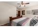 Bedroom featuring a rustic wood frame bed, ceiling fan, and a shuttered window at 11101 W Sieno Pl, Avondale, AZ 85392