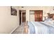 Cozy bedroom featuring a rustic wooden bed frame and carpet flooring at 11101 W Sieno Pl, Avondale, AZ 85392
