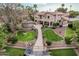 Stunning home featuring well-manicured lawns, lush landscaping, outdoor fireplace, and private dock at 11101 W Sieno Pl, Avondale, AZ 85392