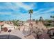 Beautiful view of home featuring desert landscaping, palm trees, and a two-car garage at 11101 W Sieno Pl, Avondale, AZ 85392