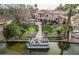 Beautiful waterfront home featuring a private dock, boat, lush landscaping, and manicured lawn at 11101 W Sieno Pl, Avondale, AZ 85392