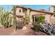 Southwestern style landscaping in front of the home features rocks, cacti, and mature desert plants at 11101 W Sieno Pl, Avondale, AZ 85392