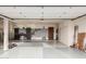 Spacious two-car garage featuring epoxy floor, custom cabinets, and slat wall storage system at 11101 W Sieno Pl, Avondale, AZ 85392