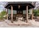 Relaxing gazebo featuring a central firepit, seating, neon signs and glass block walls at 11101 W Sieno Pl, Avondale, AZ 85392