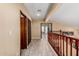 Hallway leading to the rooms on the upper level, boasting wood railing and hardwood-style flooring at 11101 W Sieno Pl, Avondale, AZ 85392