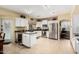Bright kitchen featuring white cabinets, stainless steel appliances, and tile flooring at 11101 W Sieno Pl, Avondale, AZ 85392