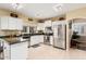 Bright kitchen featuring white cabinets, stainless steel appliances, and tile flooring at 11101 W Sieno Pl, Avondale, AZ 85392