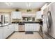 Bright kitchen featuring white cabinets and stainless steel appliances at 11101 W Sieno Pl, Avondale, AZ 85392