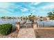 A lake view with a boat, landscaping, and a patio leading to the water at 11101 W Sieno Pl, Avondale, AZ 85392