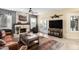 Comfortable living room featuring stone fireplace, open layout, and bright lighting at 11101 W Sieno Pl, Avondale, AZ 85392
