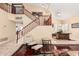 Open-concept living room with beautiful staircase, tile entryway, and hardwood floor accents at 11101 W Sieno Pl, Avondale, AZ 85392
