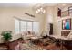 Open living room bathed in light featuring clerestory windows and dark hardwood floors at 11101 W Sieno Pl, Avondale, AZ 85392