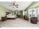 Spacious main bedroom features hardwood-style floors, ceiling fans, bay window, and ensuite bathroom at 11101 W Sieno Pl, Avondale, AZ 85392