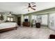 Spacious main bedroom features hardwood-style floors, ceiling fans, and bay window at 11101 W Sieno Pl, Avondale, AZ 85392