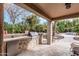 Enjoy the outdoor kitchen with built-in grill and counter space overlooking the spacious patio at 11101 W Sieno Pl, Avondale, AZ 85392