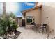 Relaxing patio area features a table with two chairs and decorative landscaping at 11101 W Sieno Pl, Avondale, AZ 85392