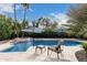 Lush outdoor space showcasing a sparkling swimming pool perfect for relaxation and enjoying the tropical backyard at 11101 W Sieno Pl, Avondale, AZ 85392