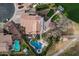 Waterfront home featuring a boat dock, swimming pool, manicured lawns, and desert landscaping at 11101 W Sieno Pl, Avondale, AZ 85392