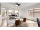 Bright living room with hardwood floors, a ceiling fan, and multiple windows at 11251 E Pratt Ave, Mesa, AZ 85212