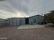 A view of the backyard featuring gravel landscaping and a shed attached to the home at 1143 S 96Th St, Mesa, AZ 85208