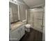 Bathroom featuring granite vanity and shower with sliding glass door at 1143 S 96Th St, Mesa, AZ 85208