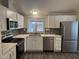 Well-lit kitchen with stainless steel appliances, white cabinets, and attractive tile backsplash at 1143 S 96Th St, Mesa, AZ 85208