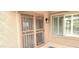 Neutral entryway with pink security door and window with white shutters at 15342 W Tasha Dr, Surprise, AZ 85374
